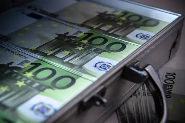 Photo of Stacks of 100 Euros in a steel Suitcase.