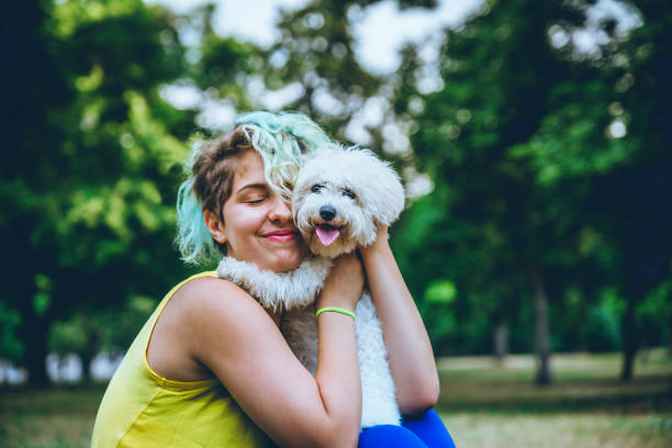 istock Young woman hugging her dog 1222856626