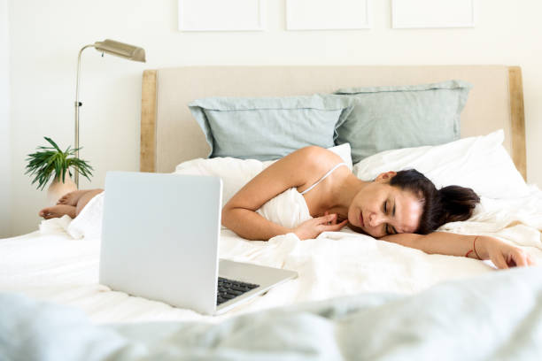 istock Hispanic mature Woman sleeping in bed with computer in the morning 1222857803
