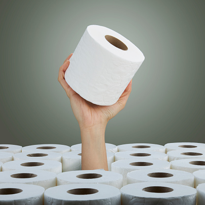 Woman hand with roll of toilet paper