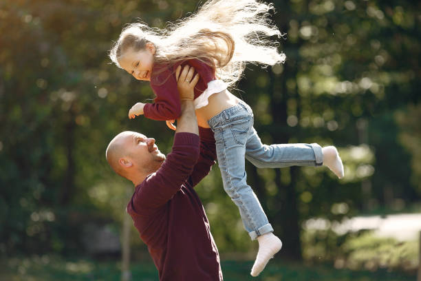 istock Cute family playing in a autumn park 1222858874