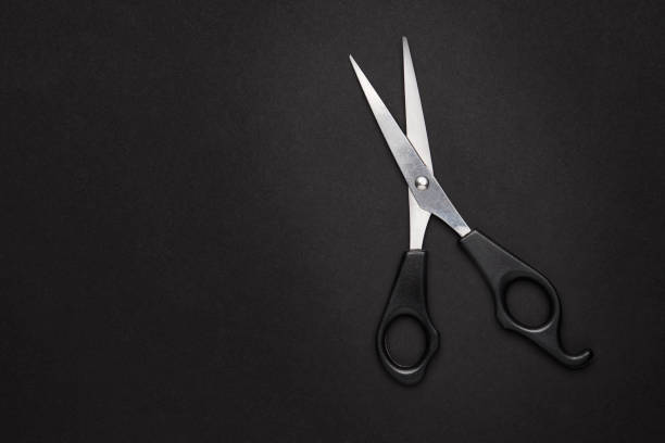 istock scissors hairdressing tool over black background with copy space. view from above. studio shot. 1222860028
