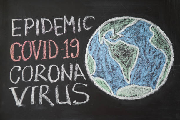 istock inscription stay at home. Outbreak Warning. written white chalk on blackboard in connection with epidemic of coronavirus worldwide. 1222860421