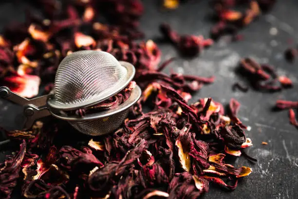 Red Hibiscus tea on the rustic background. Selective focus. Shallow depth of field.