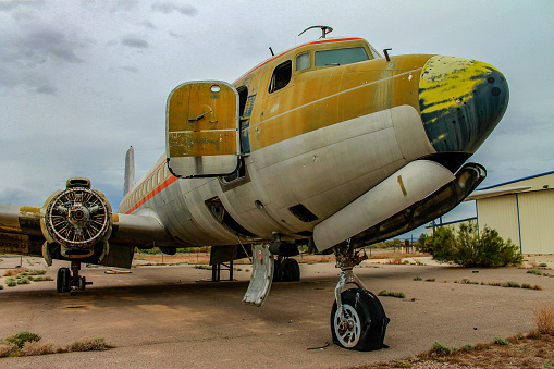 Ruins of yellow and white airplane in abandoned airport