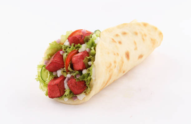 wrap sandwich naan bread tandoori paprika with salad isolated on white background wrap sandwich naan bread tandoori paprika with salad isolated on white background taftan stock pictures, royalty-free photos & images