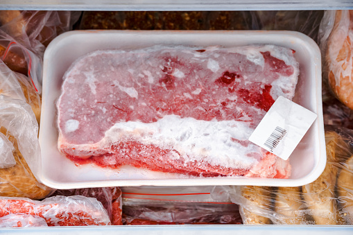 frozen meat and other foods in the fridge freezer compartment