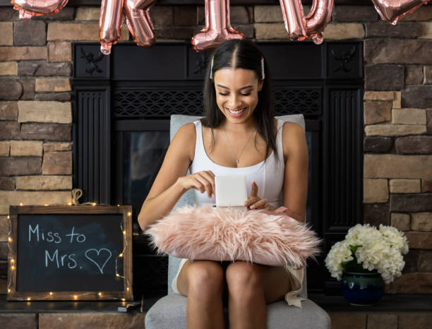 istock Soon to be bride opening a small gift box at her bridal shower 1222865383