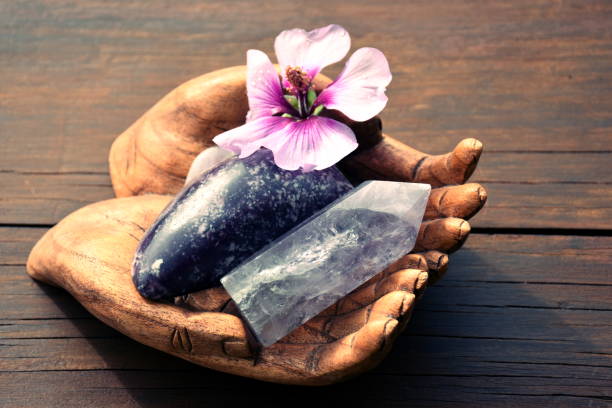 Buddhas Hands Altar Holding Purple Crystals and Hibiscus Flower Buddhas Hands Altar Holding Purple Crystals and Hibiscus Flower for Meditative Contemplation. crystal altar stock pictures, royalty-free photos & images