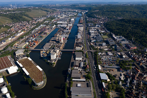 Large group of industrial estates located along the river in Germany, aerial view.