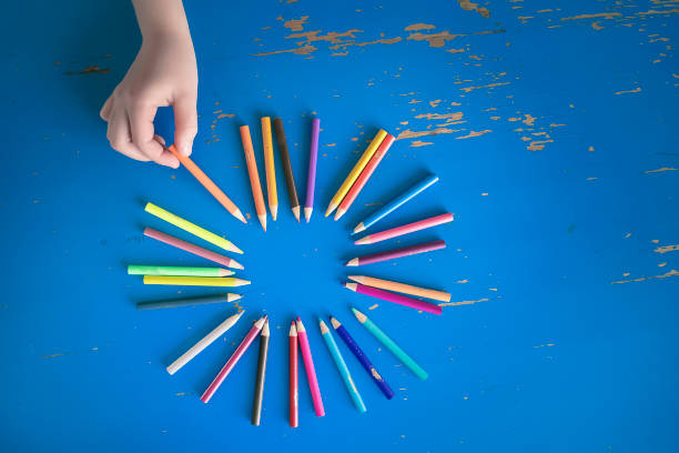 istock Young Child Picking Up A Colored Pencil 1222871125