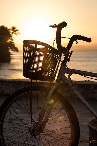 Silhouette of a bike at sunset on Guaruja, Brazil.