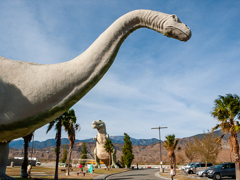 Cabazon, CA USA - A view of Ms Dinny, the Brontosaurus gift shop and and Mr Rex, a 100-ton Tyrannosaurus rex, at the roadside attraction off interstate 10 highway known as Claude Belle's Dinosaurs. Cabazon, California
