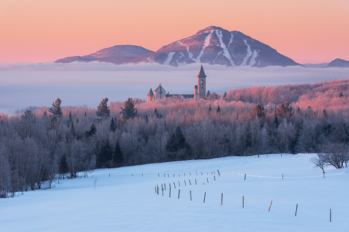 Church, snow,trees in pink colorful sunrise,countryside, easternship