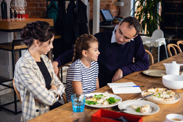 istock Young parents helping their daughter to compose a letter 1222873940
