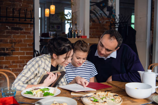istock A family reading a book after a nice meal 1222873960