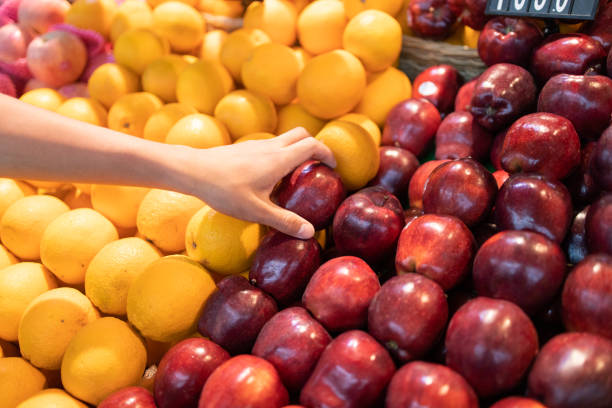 istock Picking up apple in supermarket 1222878131