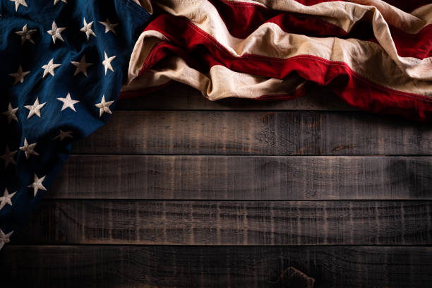 istock Happy Memorial Day. American flags with the text REMEMBER & HONOR against a old wooden background. May 25. 1222879241