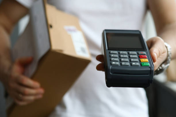 istock Man holds terminal app for payment and parcel 1222879270