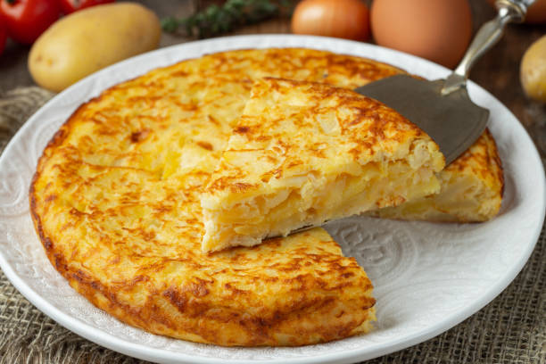 istock Spanish omelette with potatoes and onion, typical Spanish cuisine. Tortilla espanola. Rustic dark background 1222879852