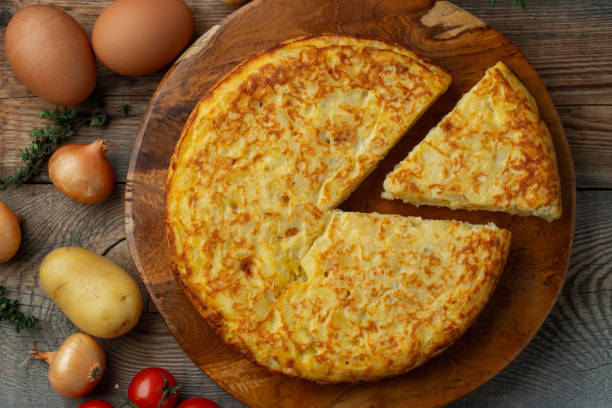 istock Spanish omelette with potatoes and onion, typical Spanish cuisine. Tortilla espanola. Rustic dark background. Top view 1222879854