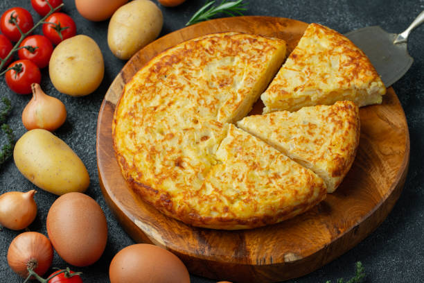 istock Spanish omelette with potatoes and onion, typical Spanish cuisine. Tortilla espanola. Rustic dark background. Top view 1222879855