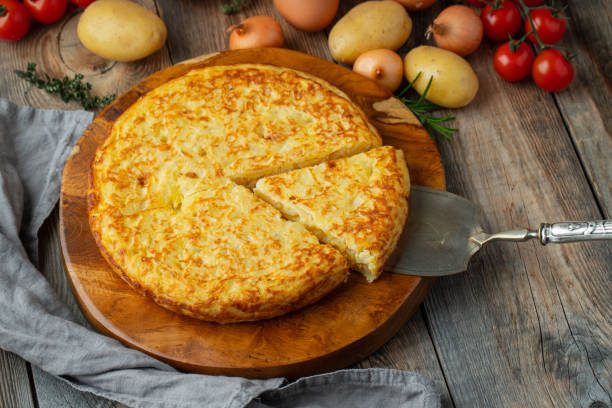 istock Spanish omelette with potatoes and onion, typical Spanish cuisine. Tortilla espanola. Rustic dark background. Top view 1222879861