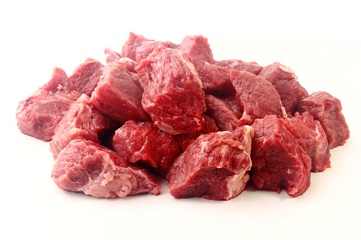 pile of diced chopped raw beef cube isolated on white background. Front view