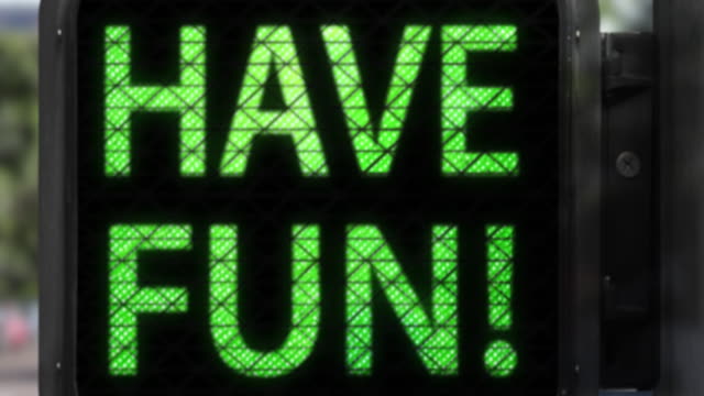 Don't Panic. Have Fun!—Closeup of Walk Signal with fun phrase