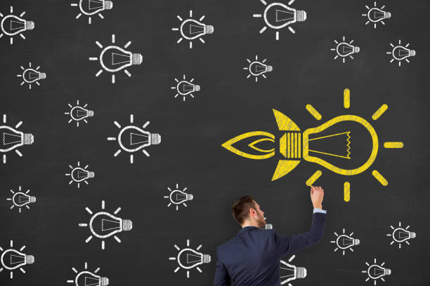 istock Going Your Own Way with Light Bulb Symbol on Blackboard Background 1222889389