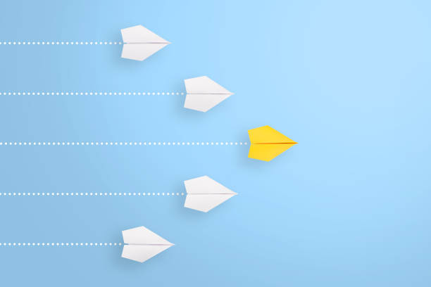 istock Leadership concepts with yellow paper airplane leading among white 1222889774