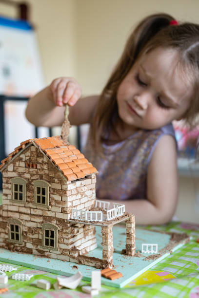 istock Boy Builds Brick House 1222894126