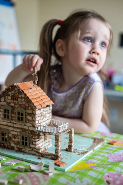 istock Boy Builds Brick House 1222894135