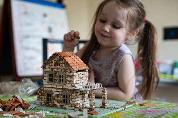 istock Boy Builds Brick House 1222894153