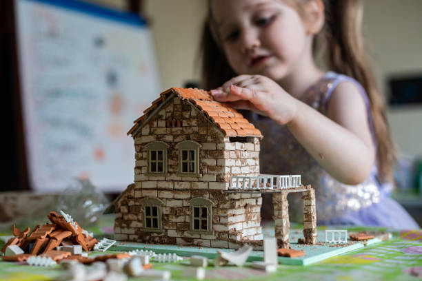 istock Boy Builds Brick House 1222894156