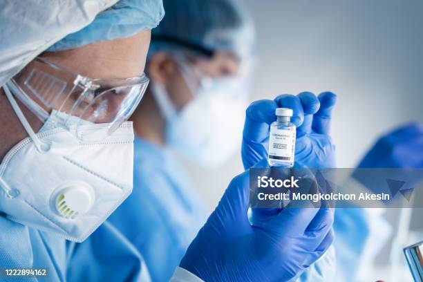 Coronavirus Covid19 Vaccine Bottle In Hands Of Pharmacuetical And Vaccine Research Scientist In Laboratory Coronavirus Covid19 Vaccine Development Stock Photo - Download Image Now
