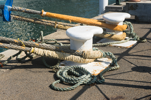 Maritime ropes looped around metal anchors