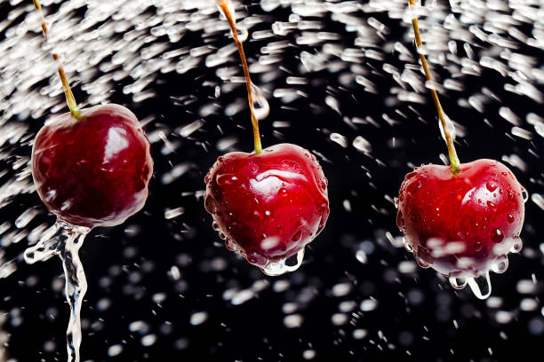 istock ripe cherries in water spray in the black background 1222897648