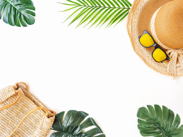 istock Summer accessories concept from sunglasses, straw hat and tropical palm leaf branches on white background with empty space for text. 1222899863
