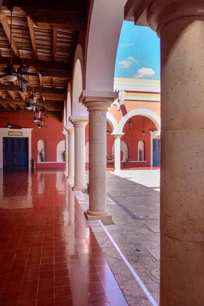 A row of columns in a mexican hacienda. Red-brown shades.