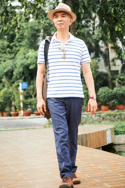 istock Senior man walking in park 1222903032