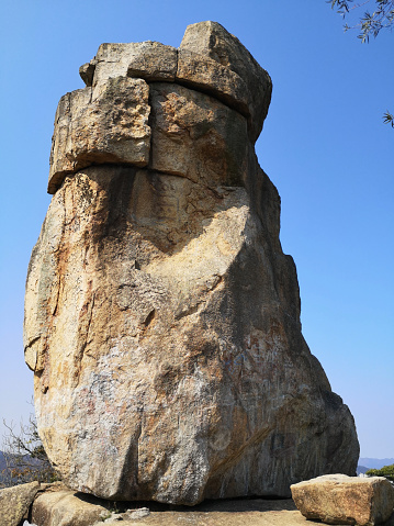 Amah Rock, a naturally shaped rock located on a hilltop in southwest Sha Tin District, Hong Kong. The rock is approximately 15 meters in height, and is within Lion Rock Country Park.
