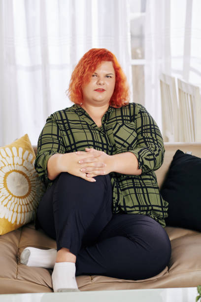 istock Overweight woman resting on sofa 1222907751