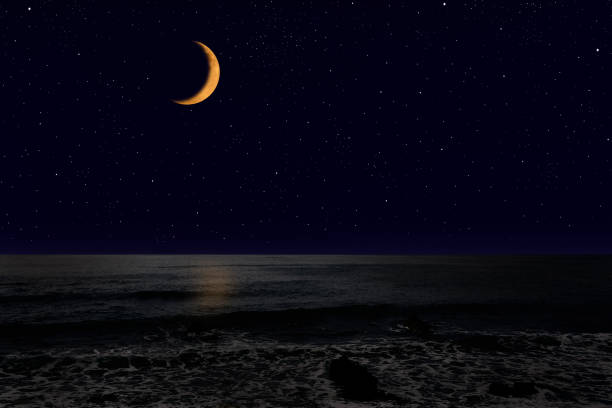 istock Crescent moon rising over the sea. 1222909533