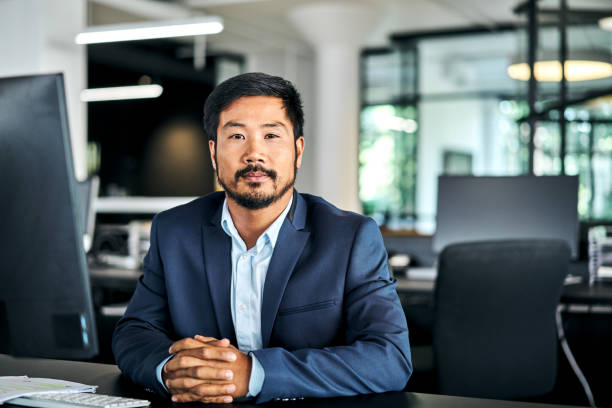 istock Portrait of executive with hands clasped at office 1222911610