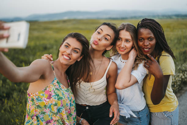 istock Cheerful girlfriends taking selfie in nature 1222913849