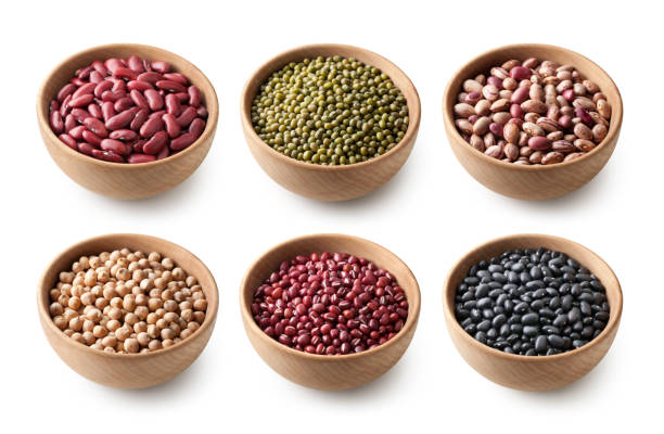 Variety of legumes in wooden bowls. Red kidney beans. Mung beans. Borlotti beans. Chick peas. Azuki beans. Black beans. Variety of legumes in wooden bowls isolated on white background. red mung bean stock pictures, royalty-free photos & images