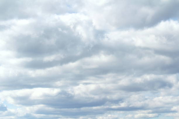 istock Clouds in the blue sky at sunset or dawn backlit by the sun. Place for text and design 1222916003