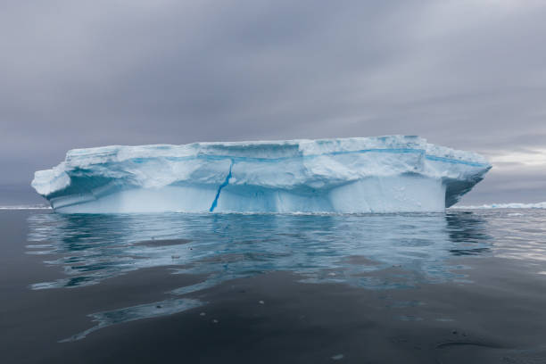 istock World climate change problems. Melting glacier. Antarctica amazing white frozen blue landscape. 1222917286