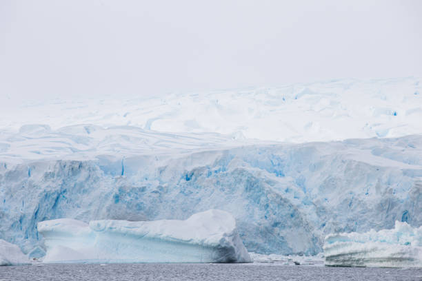istock World climate change problems. Melting glacier. Antarctica amazing white frozen blue landscape. 1222918026